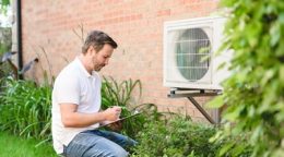 a/c technician quoting work for an air conditioner outside a home