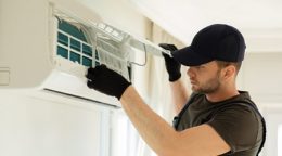 a/c technician working on a mini split a/c unit