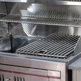 Stainless steel outdoor barbecue grill with multiple ribbed metal racks inside.